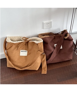 Detail view of large faux suede tote bags with fleece lining in camel and dark coffee