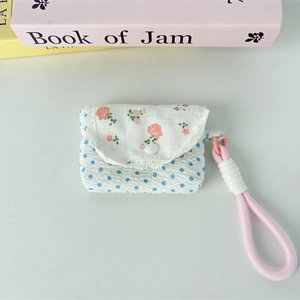 Floral print storage pouch with lace trim and polka dot pattern for wireless earphones