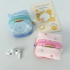 Mini floral wireless earphone case with waffle fabric texture and pearl zipper pendant detail