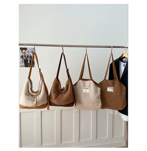Collection of plush suede tote bags in cream, caramel, and brown with chic embroidery