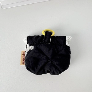 Detail of black quilted earphone pouch with a yellow ring hook and soft fabric texture