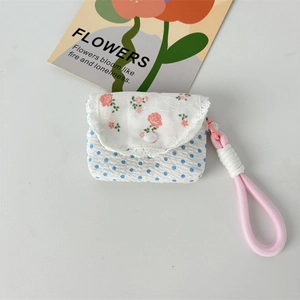 Close-up of floral patchwork fabric earphone case with lace trim and pink wrist strap