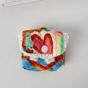 Close-up of quilted floral earphone pouch with white lace trim and pink snap closure