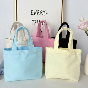 Detail of minimalist canvas tote bags in macaron colors for lunch or daily commuting