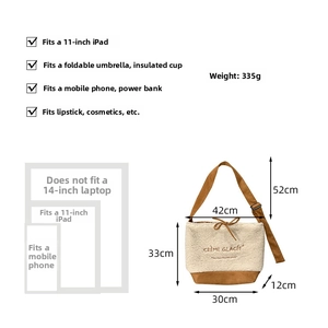 Detail of suede tote bag showing dimensions 42x33cm and 335g weight capacity info