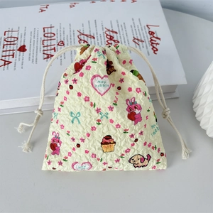 Macro shot of quilted texture and cute cartoon print on a mini drawstring storage bag
