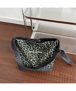 Detail of green leopard print canvas tote with denim stitching and Bonne journée text