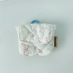 Close-up of quilted floral earphone pouch with lace trim and blue hanging hook