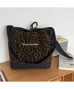 Detail of leopard print canvas bag with denim stitching and Bonne journée lettering
