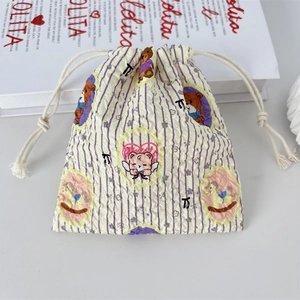 Detail of cute bear seersucker drawstring bag with purple stripes and textured fabric