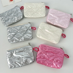 Group of shiny quilted PU leather cosmetic bags in silver, pink and rose with heart texture