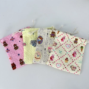 Close-up of four puff print drawstring pouches with cute cartoon animal patterns