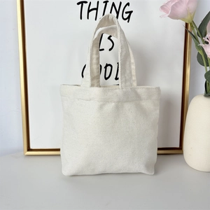 Close-up of durable cream canvas tote bag with textured weave and dual handles