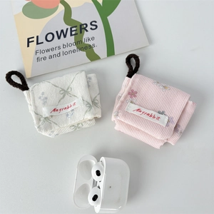 Corduroy quilted floral earbud cases in cream and pink for wireless headphones