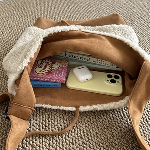 Brown faux suede crossbody bag with plush white sherpa trim and large storage capacity