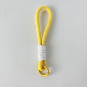 Close-up of a yellow braided rope keychain featuring a round metal spring snap hook