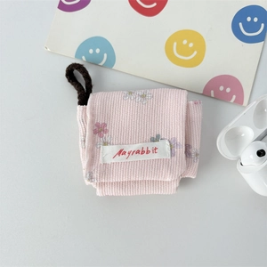 Close-up of pink corduroy floral earphone case with Mayrabbit label and side lanyard loop