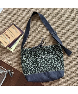 Detail of leopard print canvas and denim tote with drawstring and adjustable strap