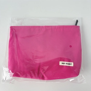 Pink canvas cosmetic bag featuring a May Rabbit label in transparent plastic packaging