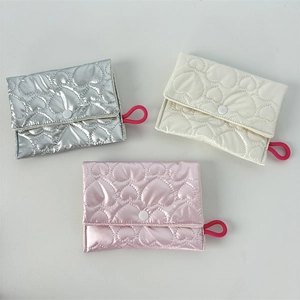 Detailed heart-quilted coin purses in silver, cream, and pink with button closure
