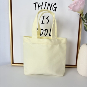 Minimalist canvas handbag in light yellow displayed as a stylish lunch tote