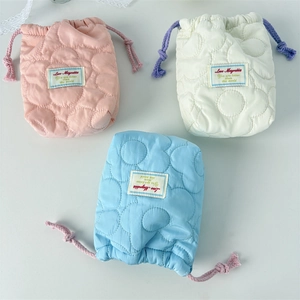 Quilted floral drawstring storage bags in pink, white, and blue for polaroid cameras