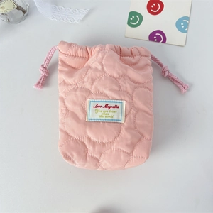Close-up of pink quilted cloud drawstring bag with Love Mayrabbit woven label on white background