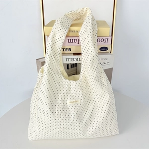 Minimalist cream polka dot tote bag with black dots for daily commuting and fashion use