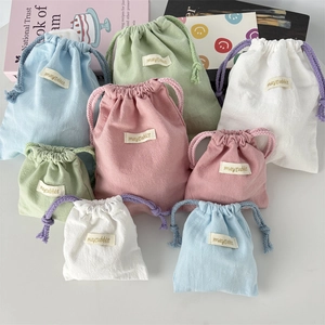 Multi-color cotton linen drawstring storage bags in pastel tones for travel organizing