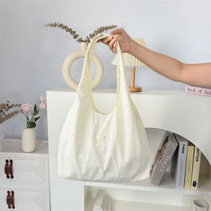 Minimalist white polka dot tote bag with long handles for daily commute and casual use