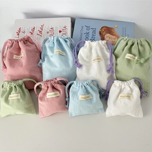Detail of macaron crepe cotton drawstring storage bags in various sizes and colors