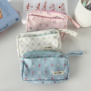 Floral and checkered corduroy pencil cases with side straps in pink, white, and blue