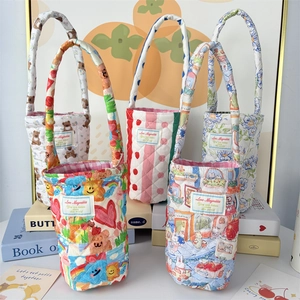 Detail of assorted quilted cotton cup holders with cartoon bear and floral patterns