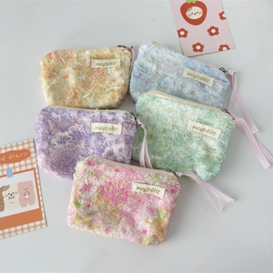 Floral lace makeup pouches in five pastel colors with vintage ribbon zipper details