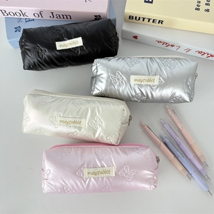 Close-up of quilted bow texture on PU pencil cases in black, silver, white and pink