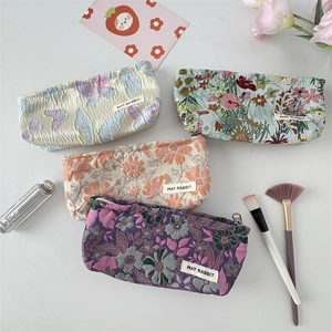 French jacquard floral makeup bags with metallic zippers in four vintage patterns