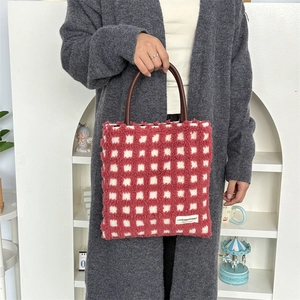 Détail du sac cabas à carreaux rouges et blancs en peluche avec anses en cuir