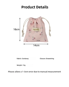 Detail view of pink floral corduroy drawstring pouch with 16x14cm dimensions and soft texture