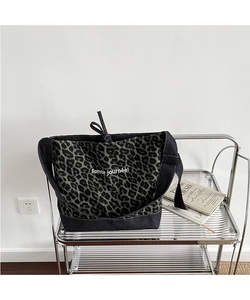 Detail of leopard print canvas tote bag with denim patchwork and Bonne journée text