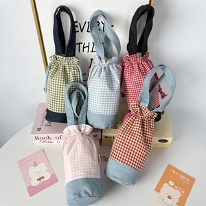 Detail of colorful plaid drawstring water bottle bags with portable handle design
