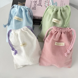 Set of four colorful crepe drawstring storage bags for home organization and travel