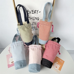 Macro view of portable checkered bottle sleeve pouches with drawstring closure handles