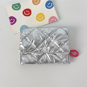 Close-up of silver quilted PU leather coin purse with metallic finish and pink rope handle