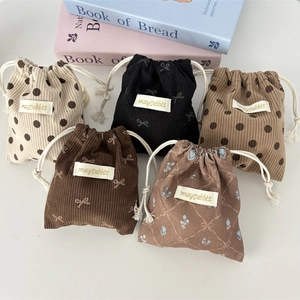 Set of five floral corduroy drawstring bags in various prints and neutral colors