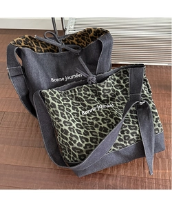 Detailed close-up of leopard print and denim tote bags with Bonne journée lettering