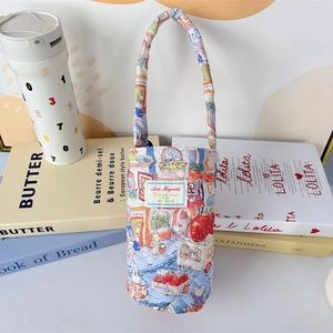 Close-up of quilted cotton cup sleeve with cute rabbit and strawberry prints