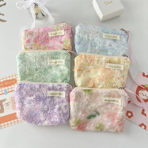 Detail of floral lace pouches in six colors with metallic zippers and shoulder straps