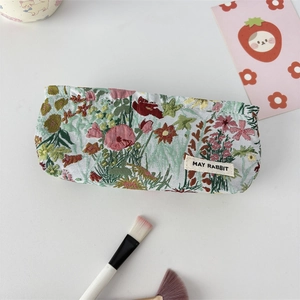 Floral jacquard makeup bag with May Rabbit label and elegant relief pattern detail