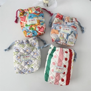 Quilted cotton drawstring camera pouches with floral patterns and cartoon illustrations