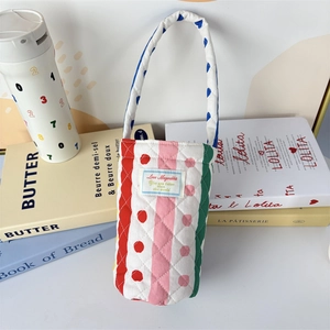 Detailed view of quilted colorful striped bottle bag with soft fabric and carry handle